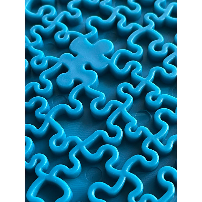 Close up of the Blue Jigsaw pieces on the Sodapup licking mat