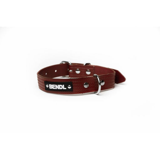 Red dog collar by the brand bendl. The collar is made from old red firehose and has silver toned hardware. The image focuses on the Bendl logo on the dog lead.