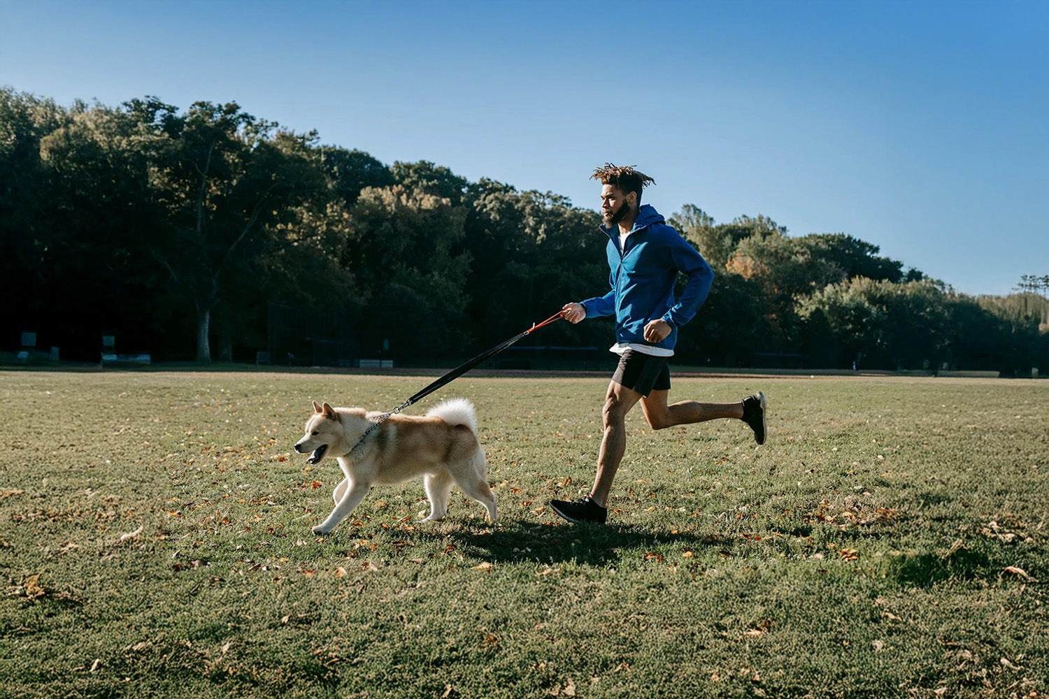 man running with dog
