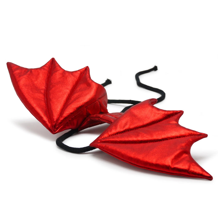 Red dragon wings with black straps on a white background