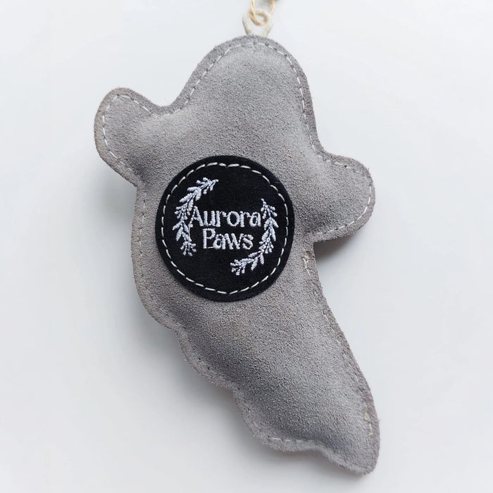 A gray felt ghost-shaped pet toy or accessory with a black circular patch reading 'Aurora Paws' in white text, shown on a plain light background.
