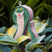 A felt snake garden ornament with a green head and body, a purple tail, and a beige underbelly, nestled among green and yellow hosta leaves.