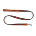 Dog leash with brown leather ends and a black and red striped middle section on a white background.