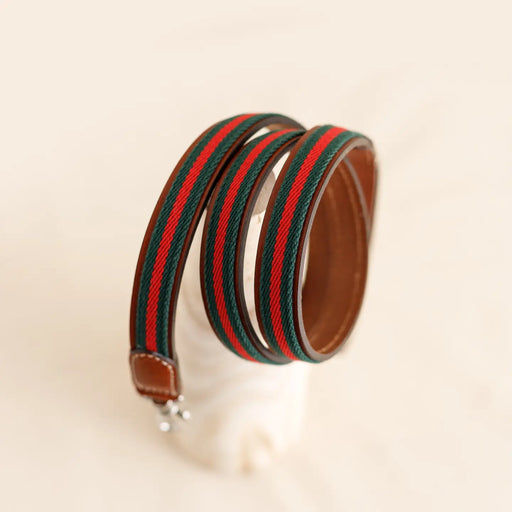 Striped dog lead rolled onto a display with a blurred cream background