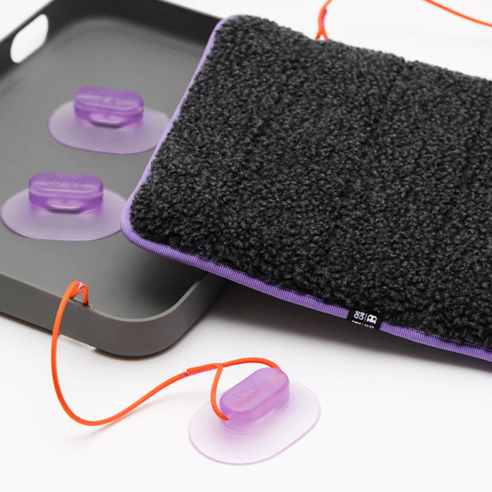 Cat bed with purple suction cups on a white background