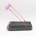 Gray pet mat with purple suction cups and orange string on a white background