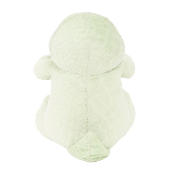 Green plush toy t-rex design on a white background
