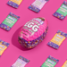 Pink Easter egg-shaped treat package with 'Denzel's' branding on a pink background