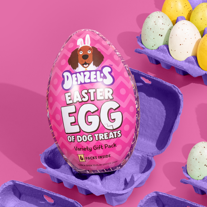 Easter egg-shaped packaging for dog treats with a pink label on a pink background
