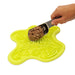 Yellow pet mat with a scoop of food on a white background