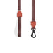 Brown dog leash with a black clip on a white background