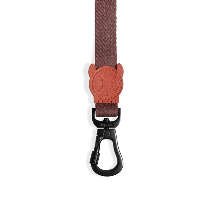 Brown dog leash with a black clip on a white background