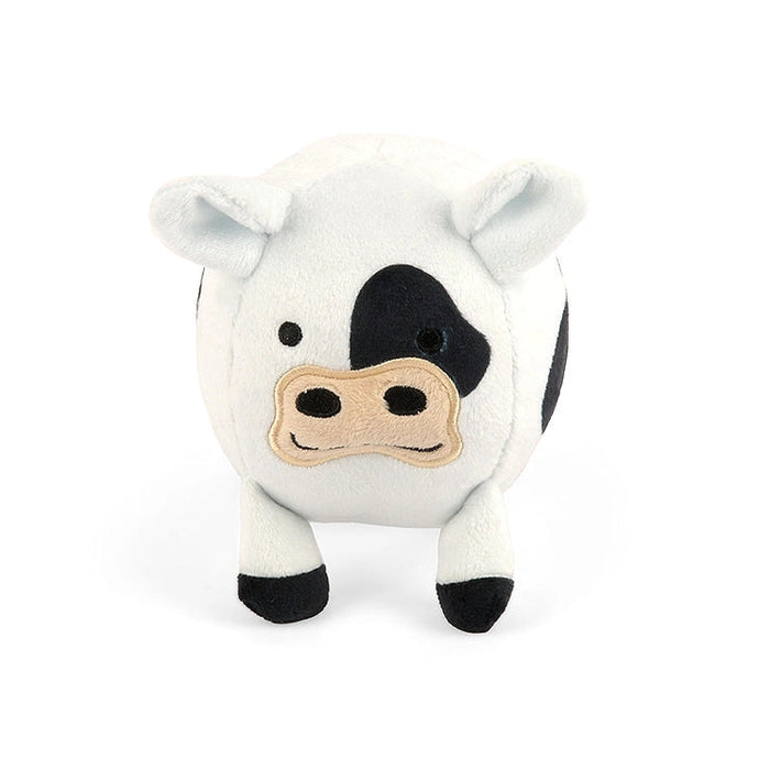 A small plush cow toy with a white body, black spots, and a beige snout, photographed against a plain white background.