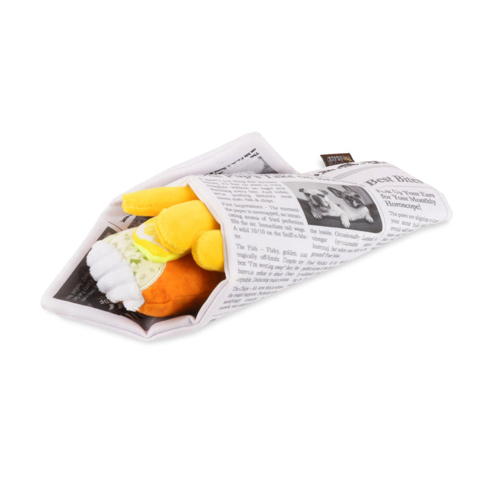 Small plush toy wrapped in newspaper on a white background