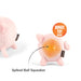 A pink plush pig toy shown from the front and back on a white background. The front view shows a sad face, and the back view shows a yellow-orange spiked ball squeaker with a black arrow pointing to it.