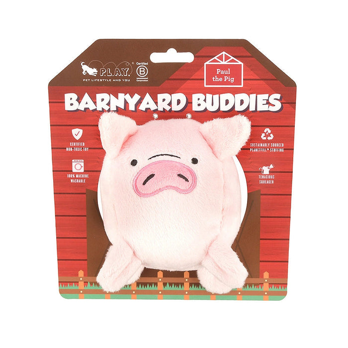 A pink plush pig toy packaged on a red barn-themed backing card labeled 'Barnyard Buddies' and 'Pull the Pig.'