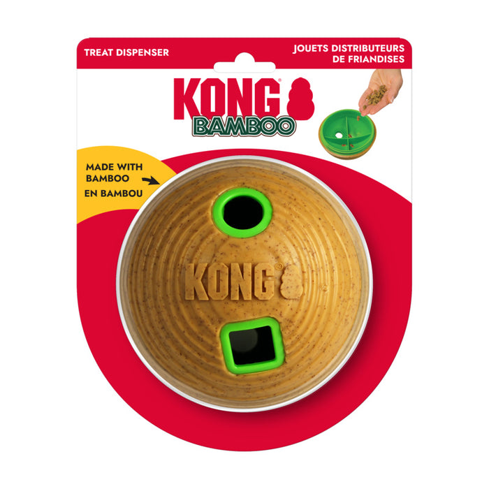 Kong Bamboo Treat Dispenser dog toy in its original blister card packaging. The product is a round bamboo disc with green plastic trim, featuring a treat dispenser hole and a square opening, with the brand name 'KONG BAMBOO' printed on the card.