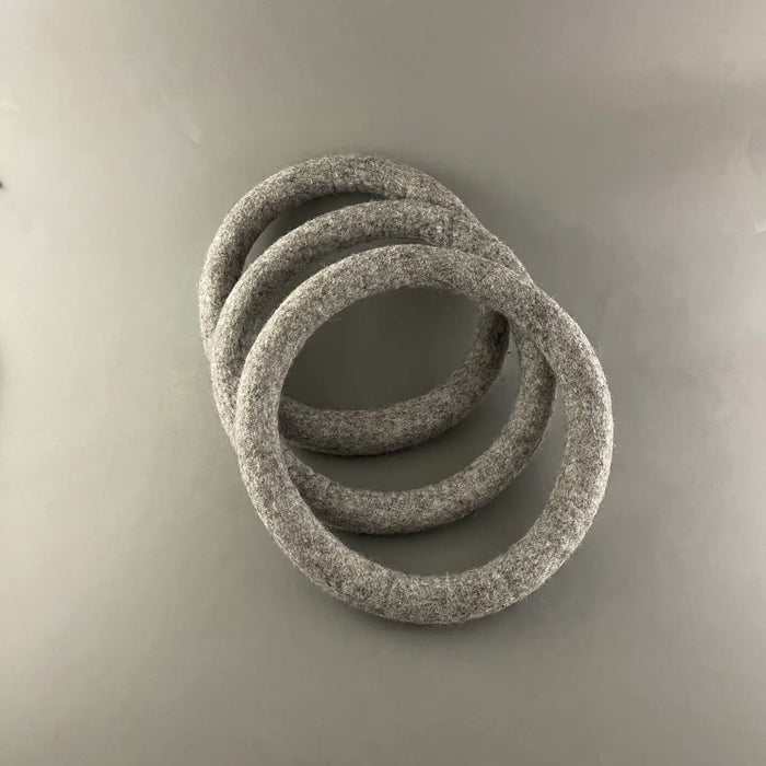 Three gray rings stacked on a gray background