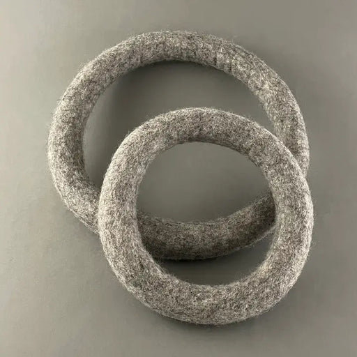 Two textured stone rings on a gray background