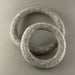 Two textured stone rings on a gray background