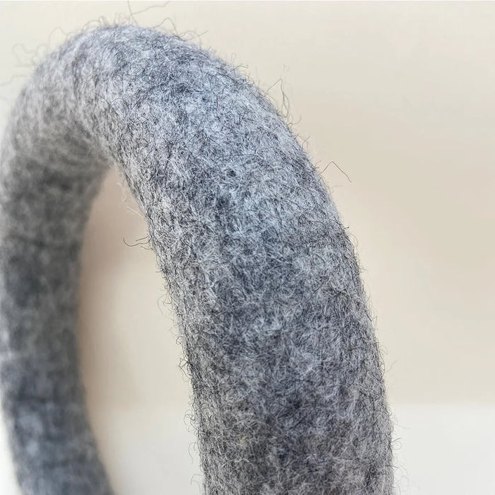 Close-up of a textured gray ring on a light background