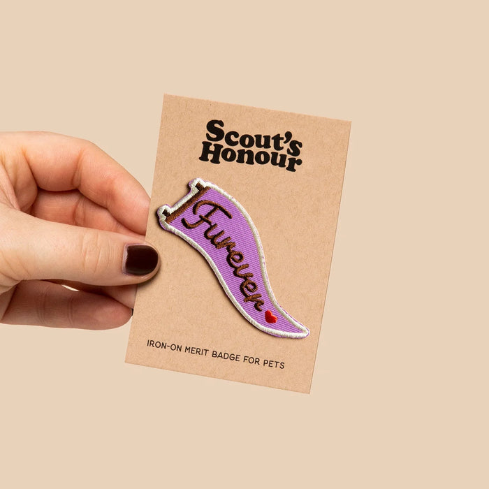 Iron-on merit badge for pets with 'Scout's Honour' text on a beige background
