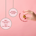 Dog treat with hand holding it on a pink background, featuring text about treats.