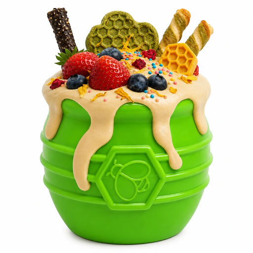 Green toy with fruit and honeycomb toppings on a white background