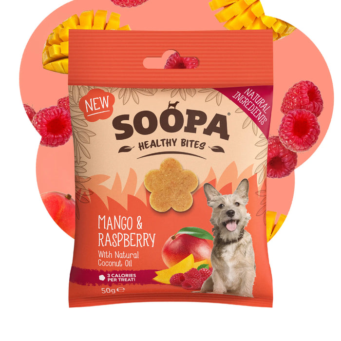 A package of Soopa Healthy Bites dog treats, Mango & Raspberry flavor, featuring a cartoon dog and fruit illustrations on the front, set against a peach background with floating raspberries and mango slices.