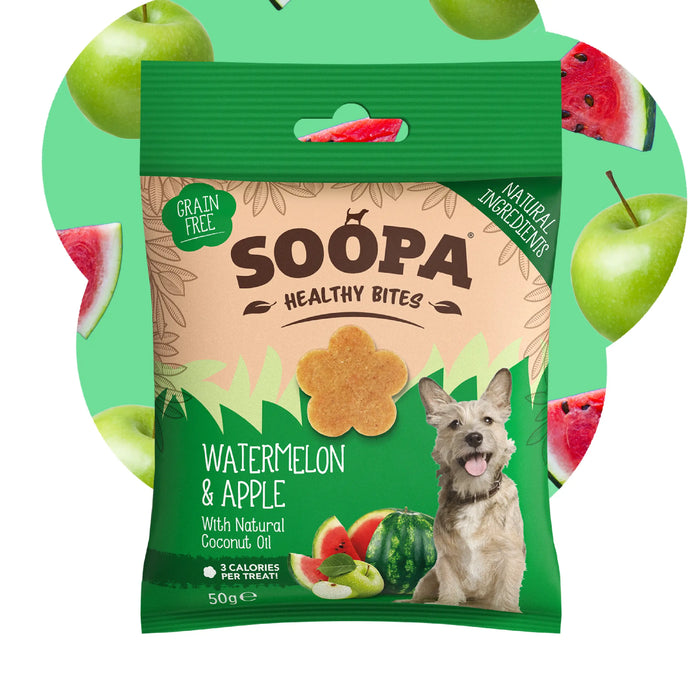 A 50g bag of Soopa Healthy Bites Watermelon & Apple dog treats, featuring a green and beige package with a picture of a dog and watermelon and apple illustrations. The background is a light green graphic with floating watermelon slices and green apples.