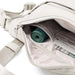 cream bag with poo bags and money