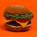 Knitted hamburger toy on an orange background