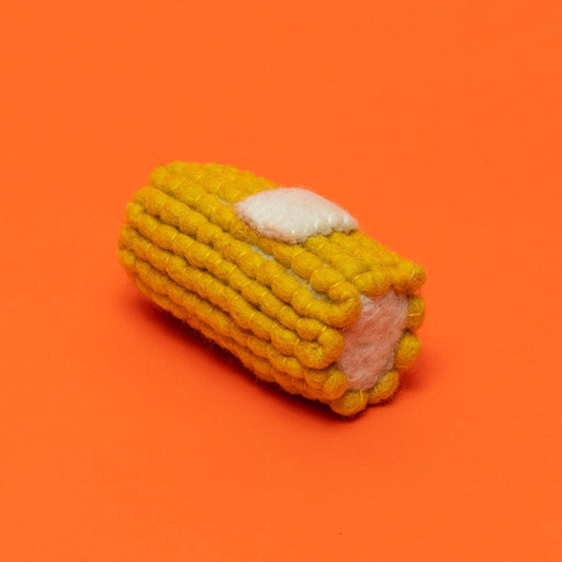 Corn-shaped toy on an orange background