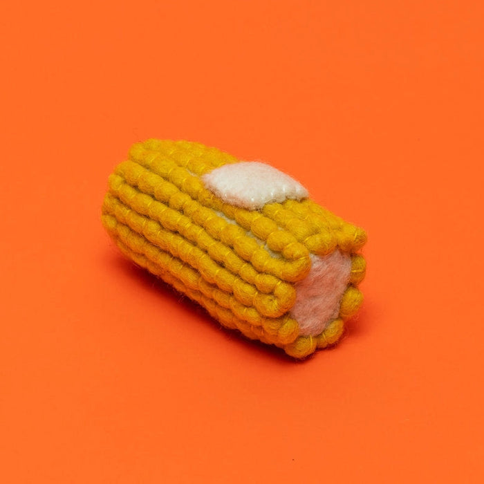 Corn-shaped toy on an orange background
