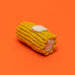 Corn-shaped toy on an orange background