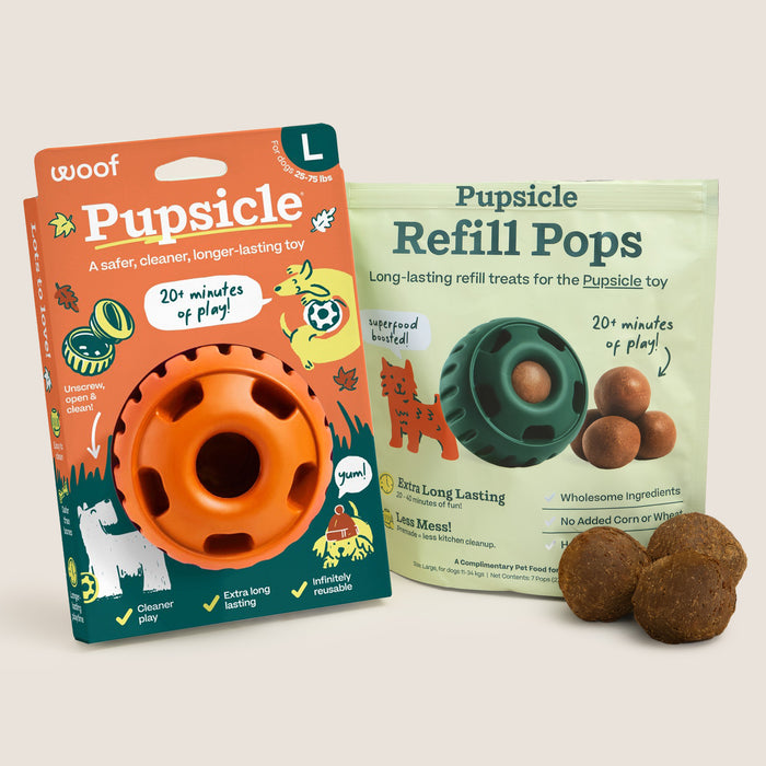 Woof Pupsicle toy refill kit including an orange Pupsicle ball inside retail packaging, a bag of Pupsicle Refill Pops treats, and three brown kibble treats on a light beige background.
