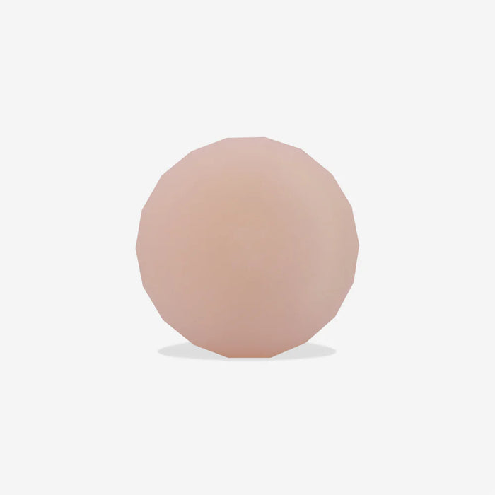 Round, pink-coloured airtag holder on a white background