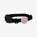 Black collar with a pink-coloured airtag holder on a white background on a white background