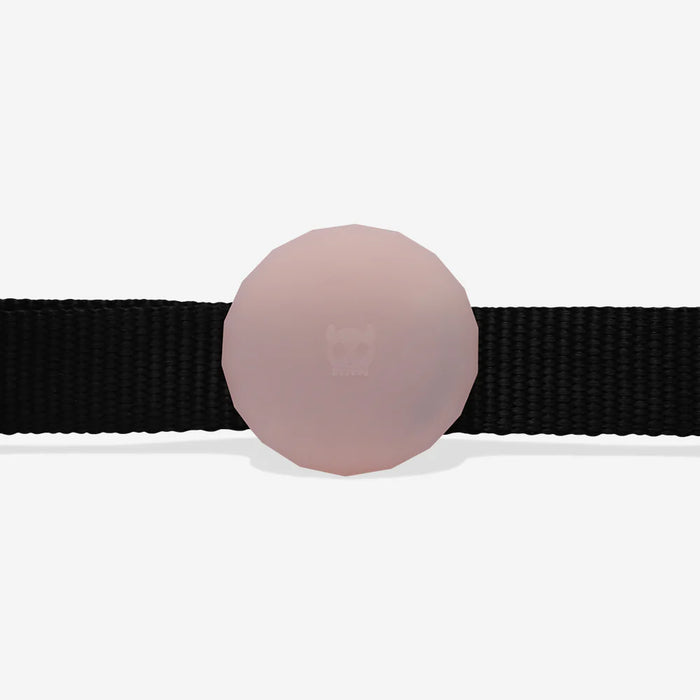 Black collar with a pink-coloured airtag holder on a white background on a white background
