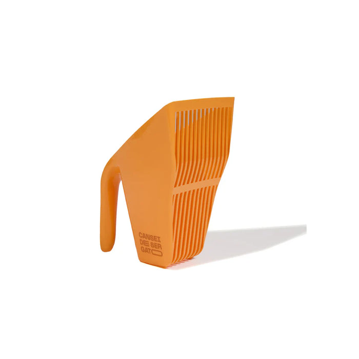 Orange scoop with a handle on a white background
