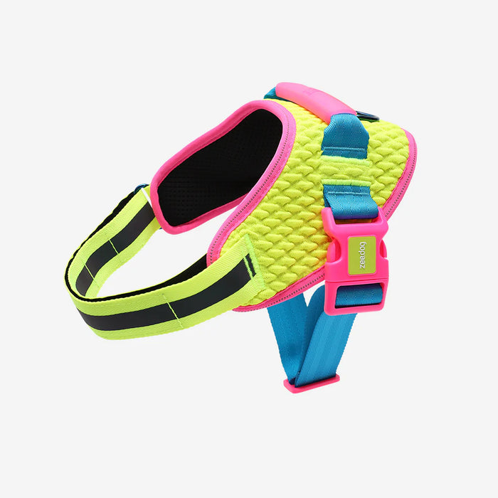 Neon green and pink dog harness with blue accents on a light gray background
