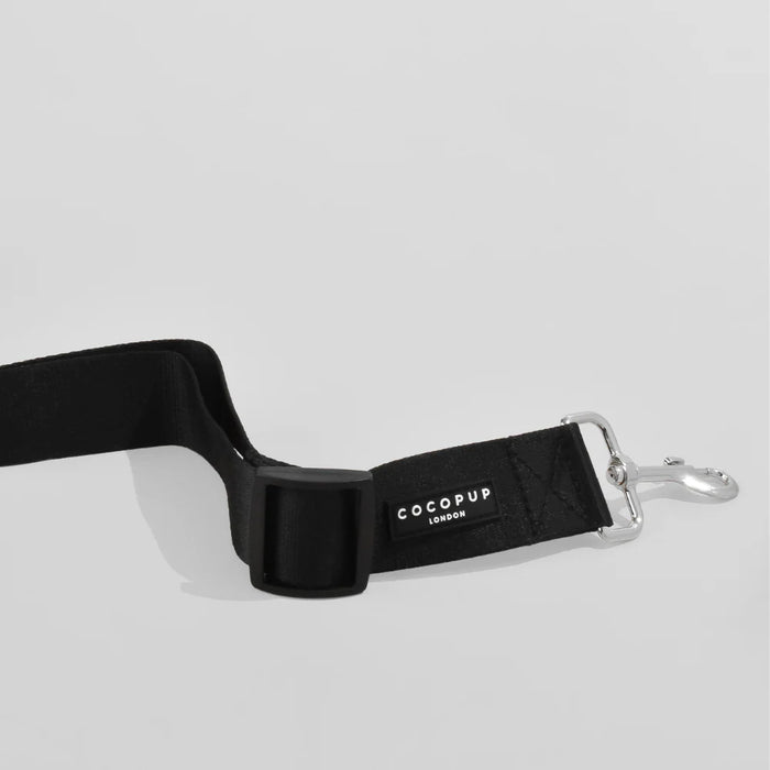 Black dog collar with 'CocoPup London' branding on a light grey background