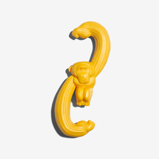 Yellow gorilla dog toy on a white background