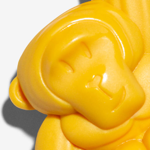 Yellow gorilla face dog toy on a white background