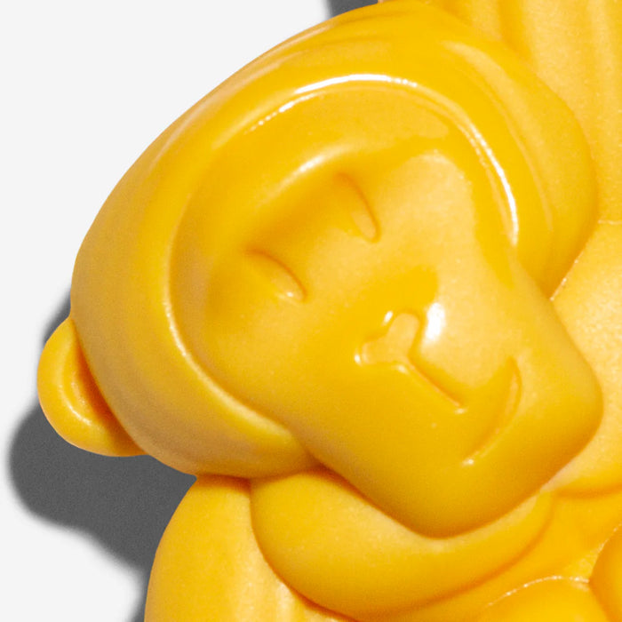 Yellow gorilla face dog toy on a white background