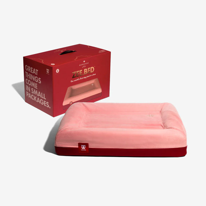 Pink pet bed with a red base with red packaging on a white background