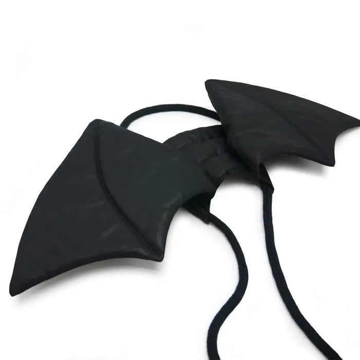 Black butterfly-shaped hair accessories on a white background