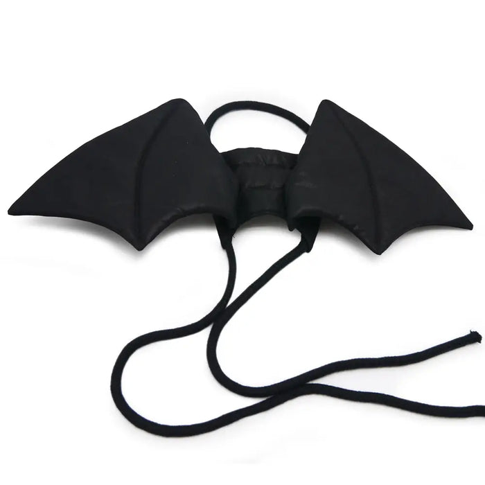 Black bat-shaped wings with a string on a white background
