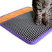 Cat standing on a textured mat with orange border and purple edge