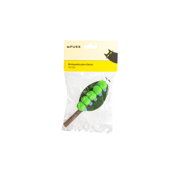 A packaged cat toy shaped like a green caterpillar on a brown twig, sealed in a clear plastic bag with a yellow and cream header card. The brand name 'FUZZ' is visible on the packaging.